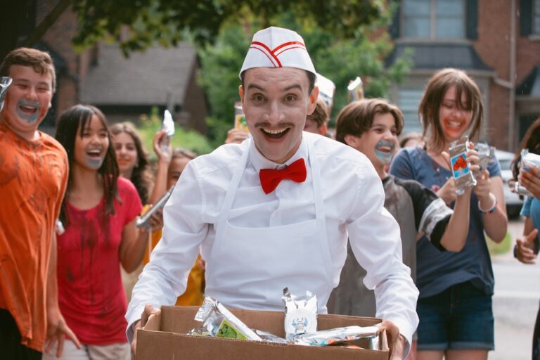 Ari Millen stands beside the ice cream truck in Eli Roth’s Ice Cream Man. Ice Cream Man digital release
