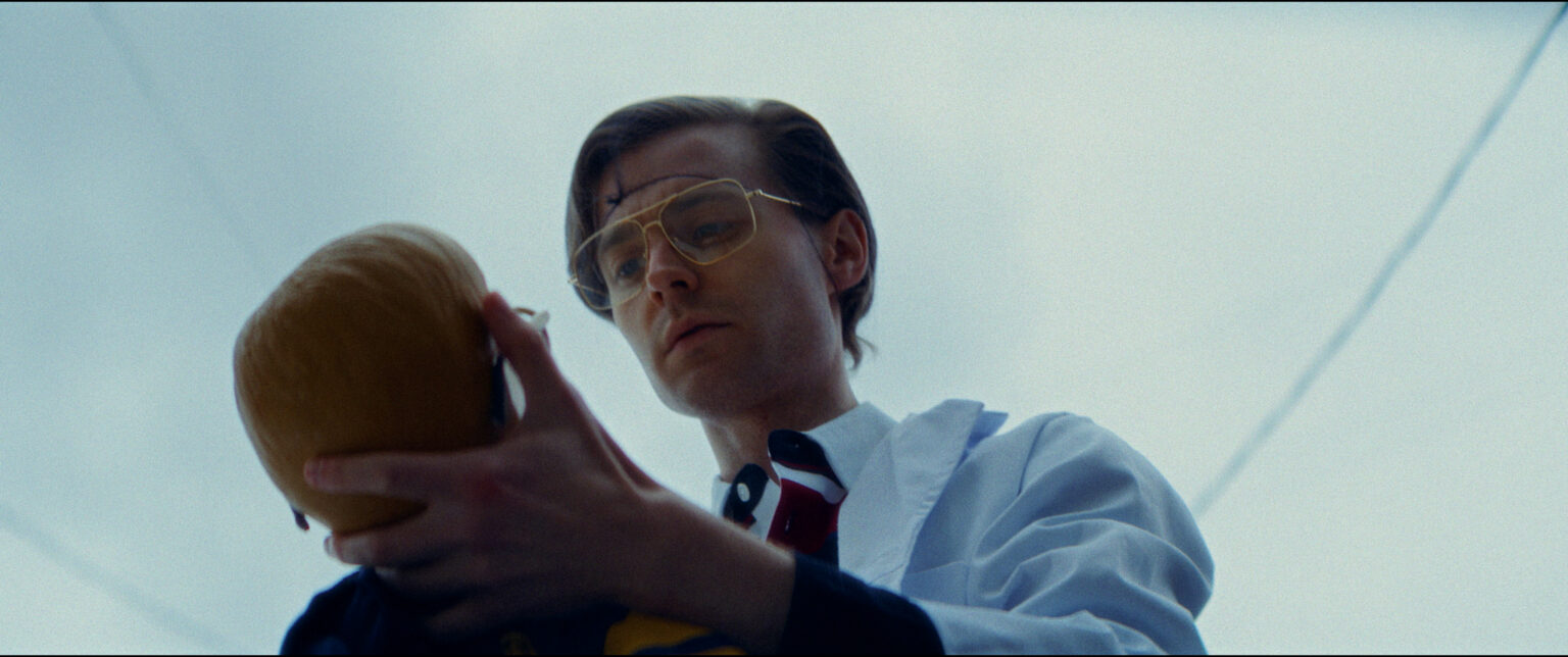A man holds the possessed doll in a scene from Jeffrey Dollmer.
