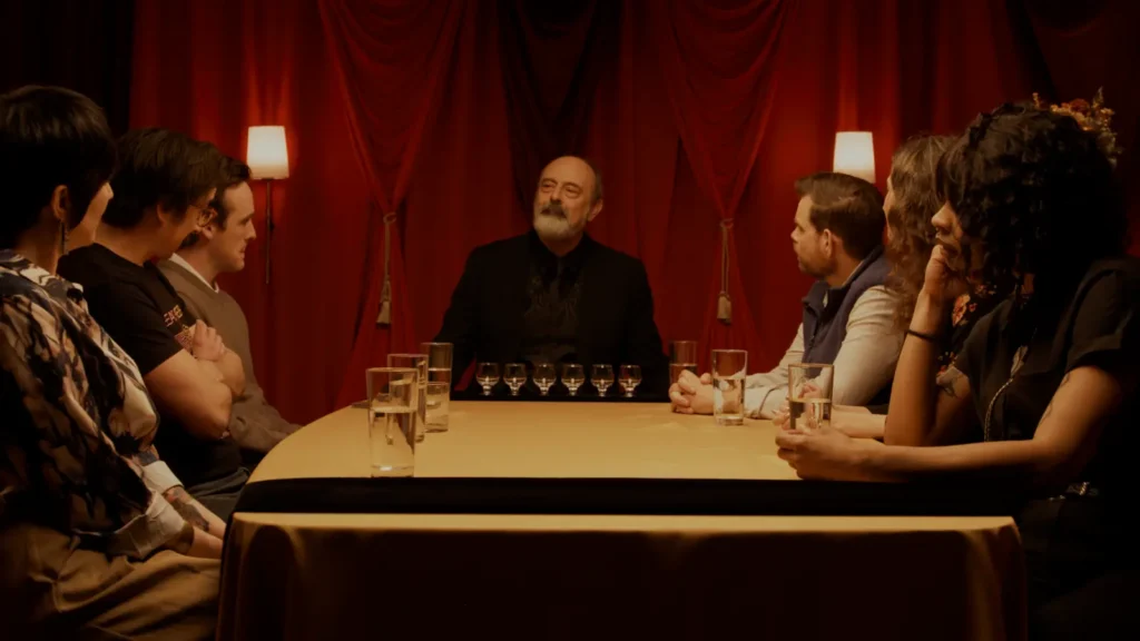The cast of Spirit Tasting gathered around a tasting table in a still from Chris LaMartina’s horror comedy.