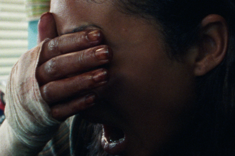 Split Rock film still of a distressed woman covering her face. Shudder Acquires Split rock